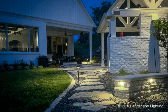 Warm pathway lighting guiding the way through a landscaped garden at night.